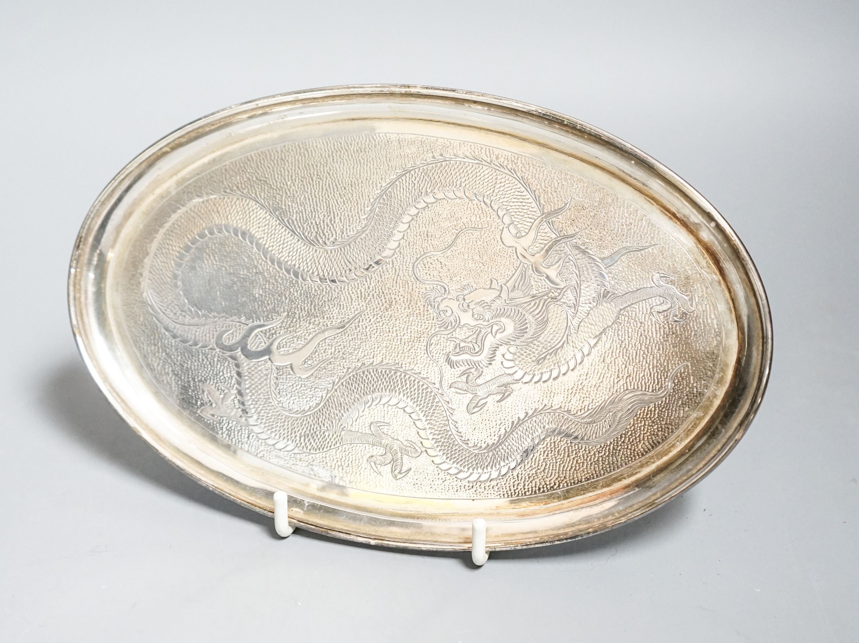 A set of six Chinese white metal tots by Tack Hing, 50mm and a small oval tray by Kingsburg, Hong Kong, 10.5oz.